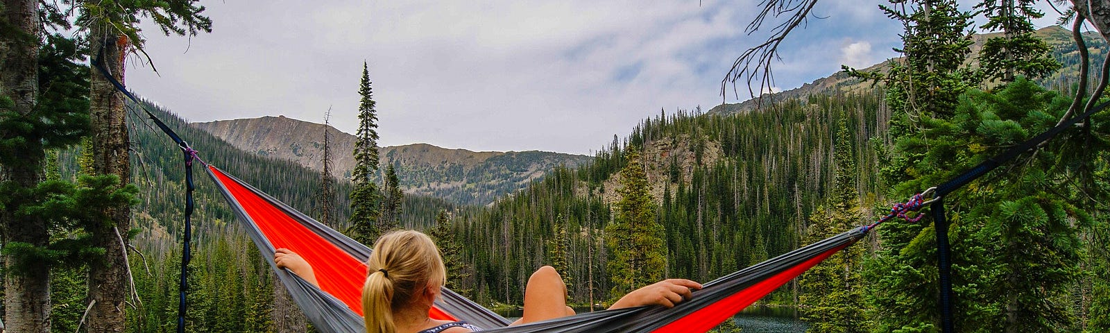 woman in hammock relaxing looking at a  view