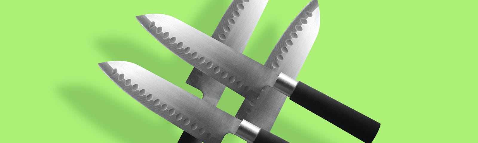 Image of 4 knives on a green background.
