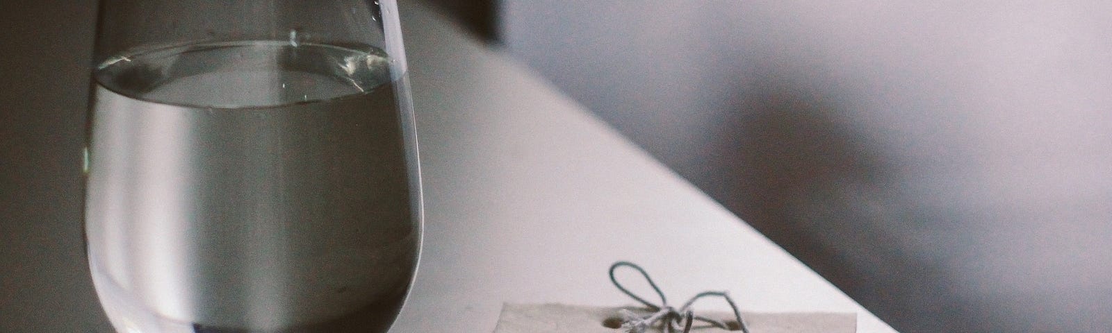 Glass of water on a desk.