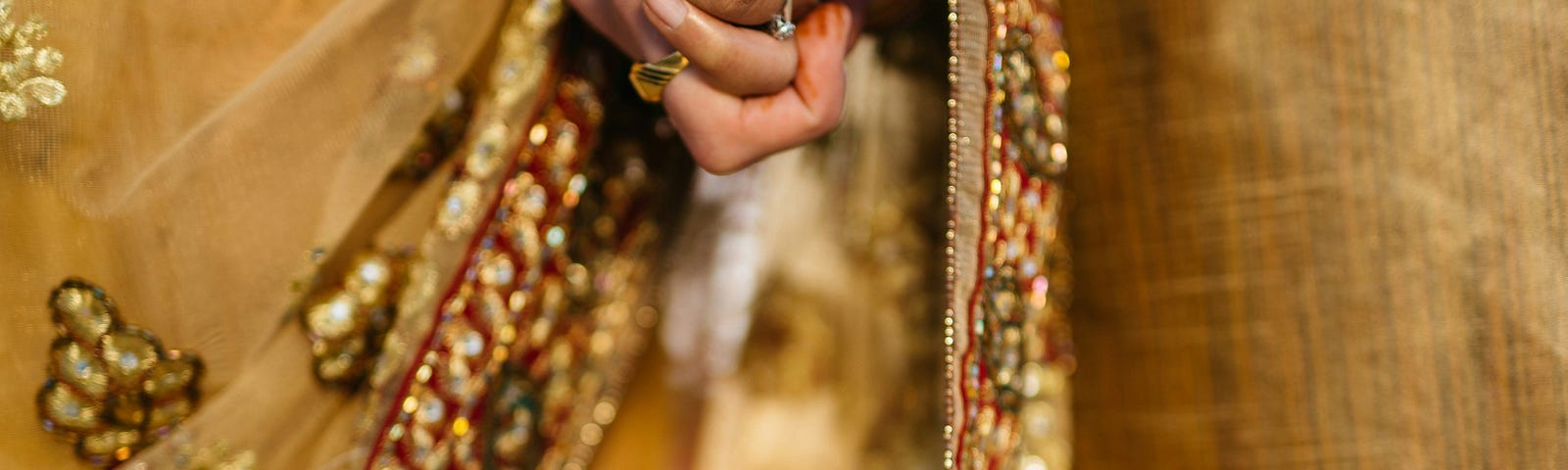 A newly married Indian couple, holding hands.