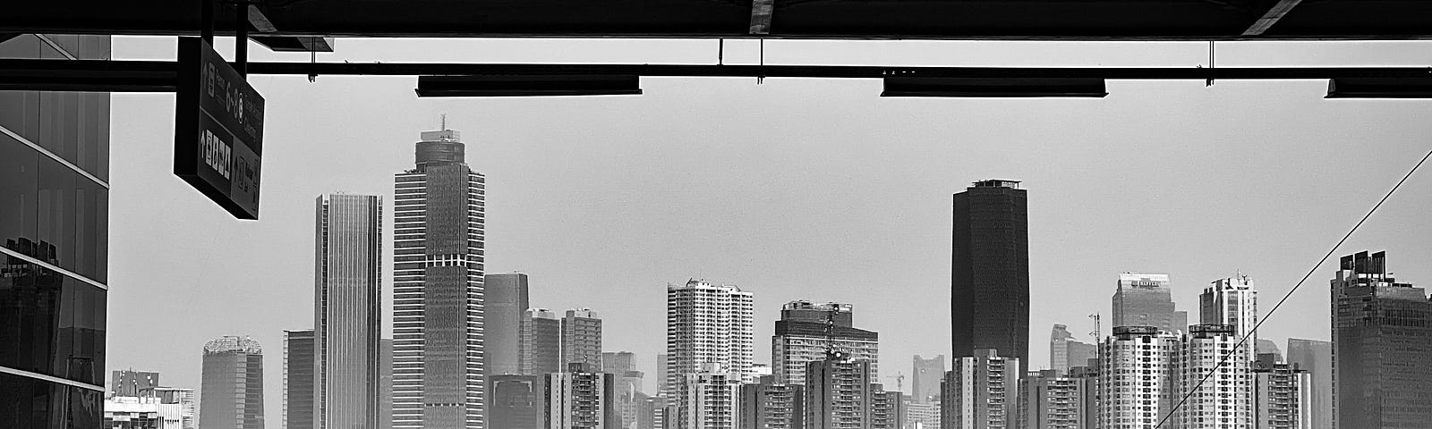 An empty station platform with a city skyline in the background