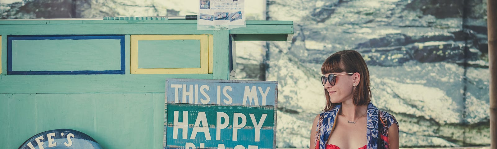 Women sitting in front of “My Happy Place” sign.