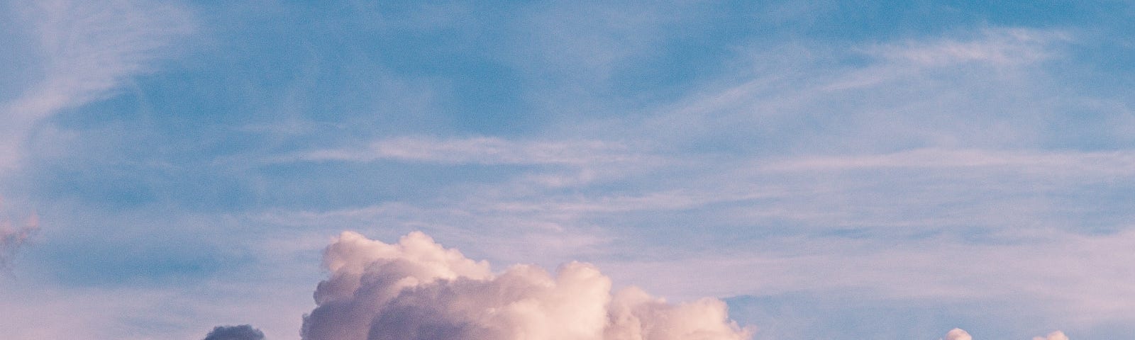 A white cloud with a pastel pink and blue background. It signifies the picturesque nature of our dreams in contrast to the parallel nature of the sacrifices one has to make to chase their dreams.
