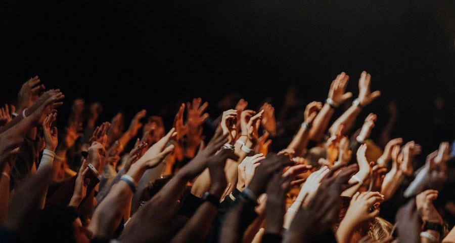 People with lifted hands in worship to God