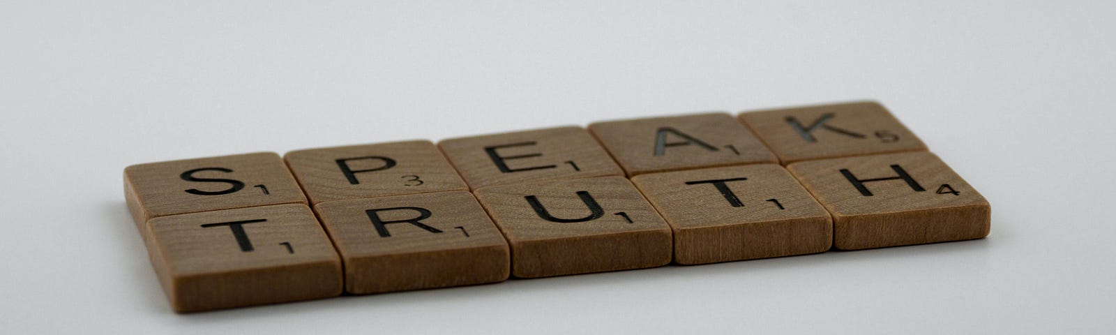 Scrabble tiles that spell “Speak Truth.”