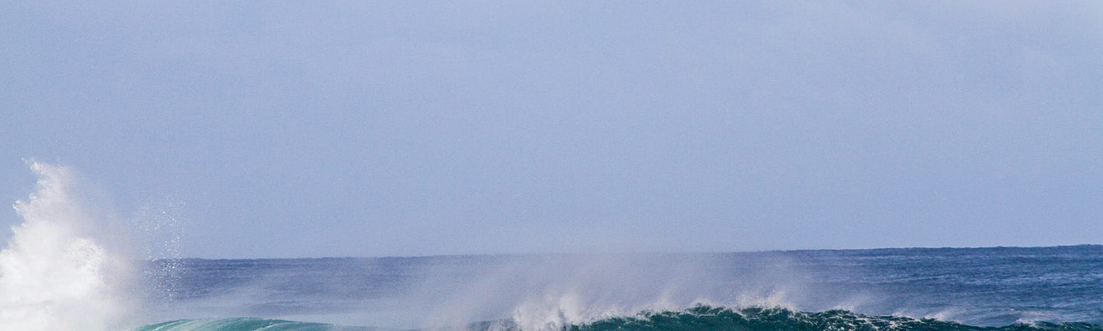 Beautiful aqua blue wave breaking left to right.