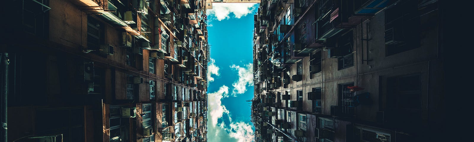 Looking at the sky from the ground level of skyscrapers.