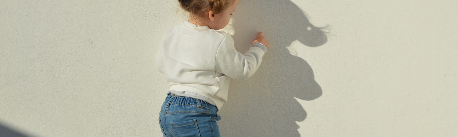 child drawing on the wall