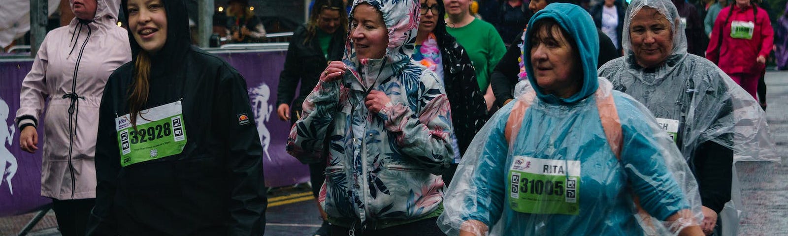 a group of women running in the rain