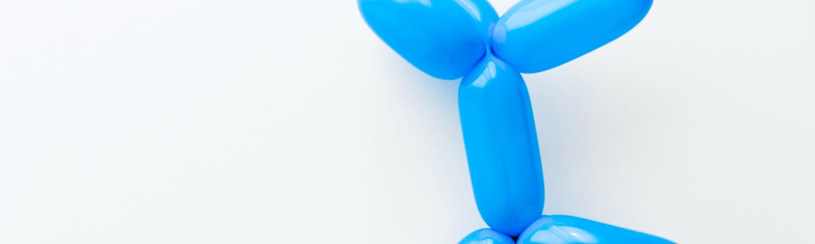 picture of a blue balloon twisted into a dog shape