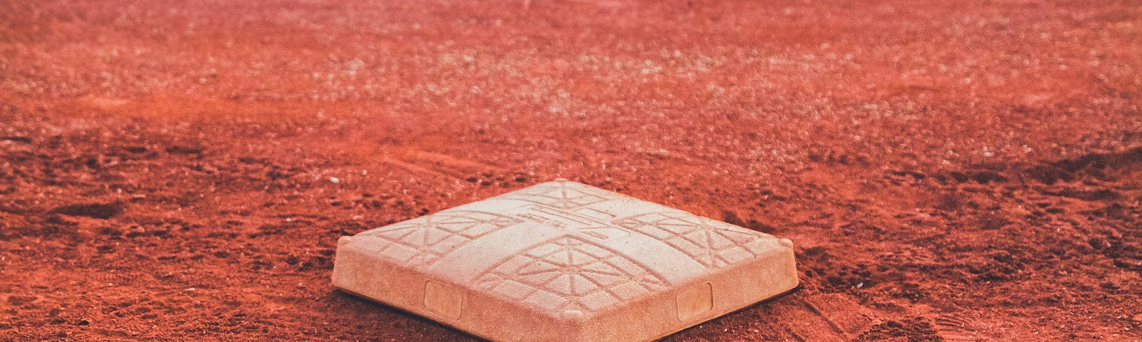 Open base on infield dirt of a baseball field