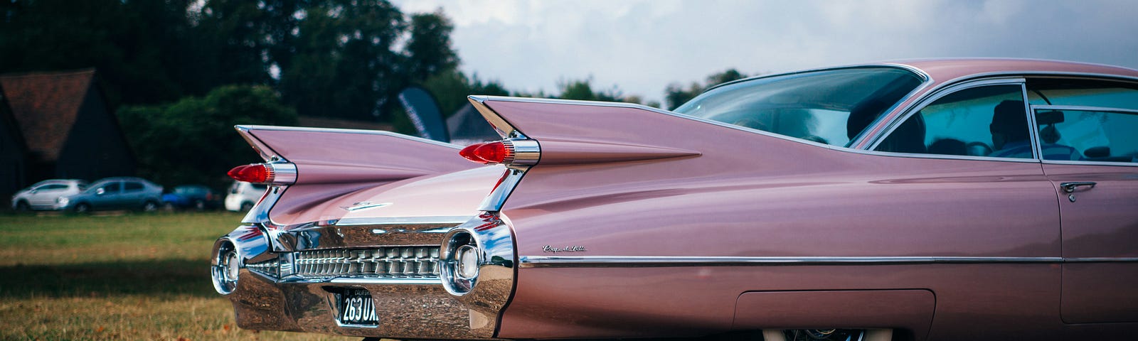 The back of a pink vintage car.
