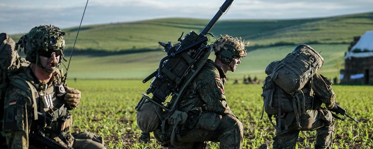 Bundeswehr paratroopers take up position after landing during NATO exercises at the 71st Airbase in Romania, May 13, 2024. Photo by Kay Nietfeld/dpa/Reuters