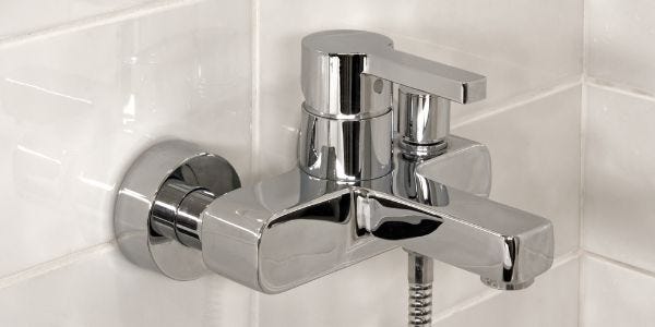 Chrome shower faucet with granite wall tiles