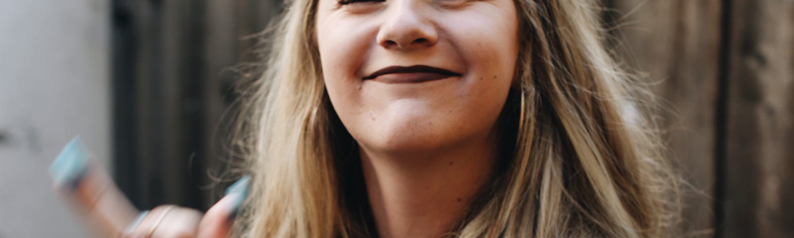 A young woman flips us the bird. She seems happy about it.