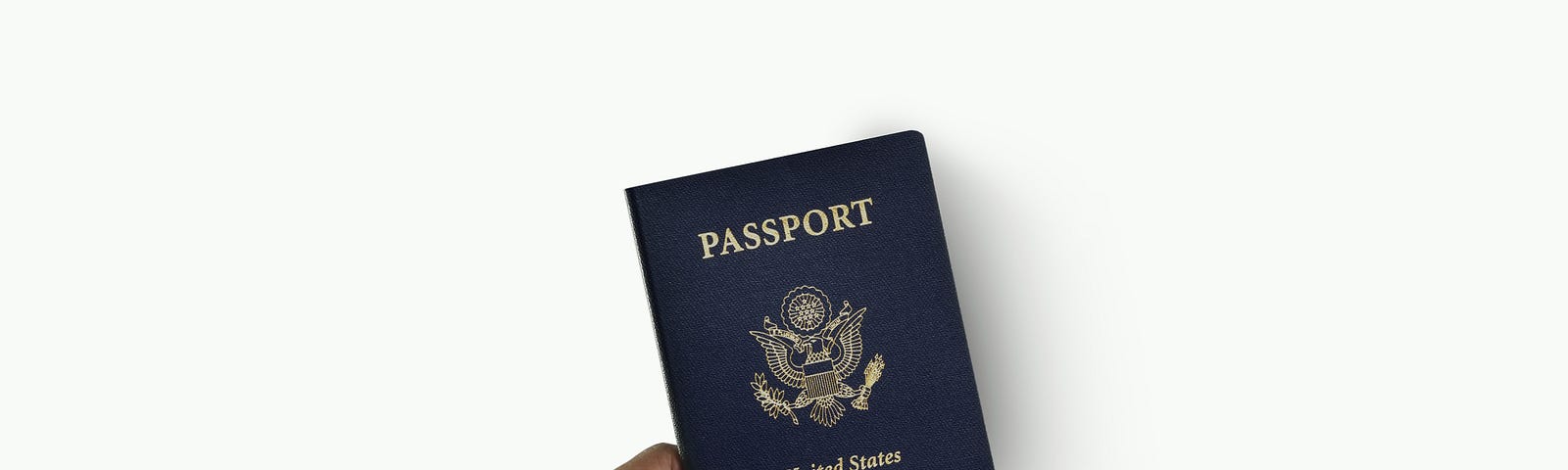 A hand holding a U.S. passport