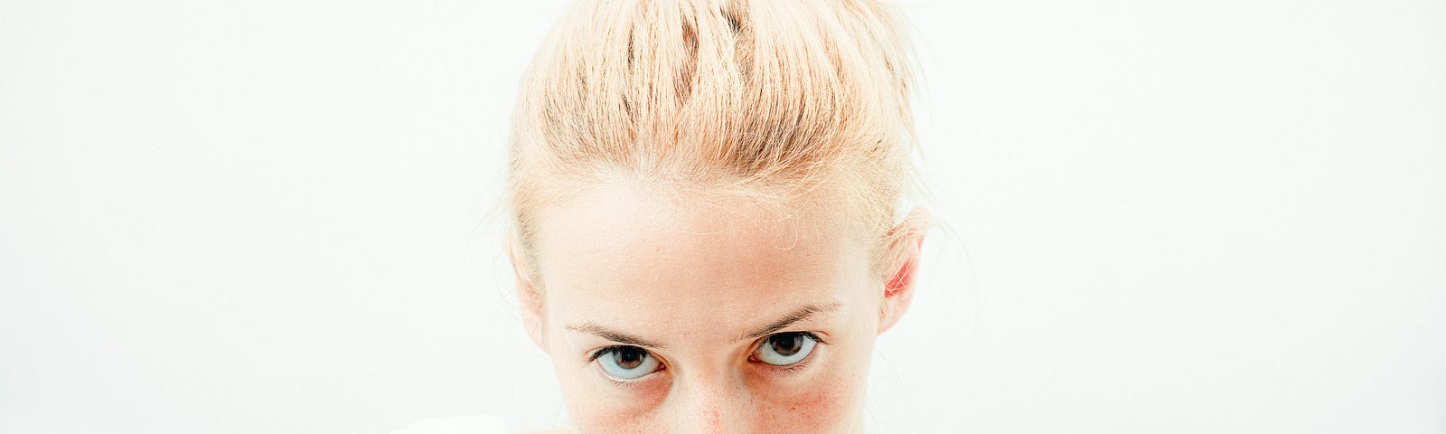 Blonde woman with a ponytail and bloodied nose