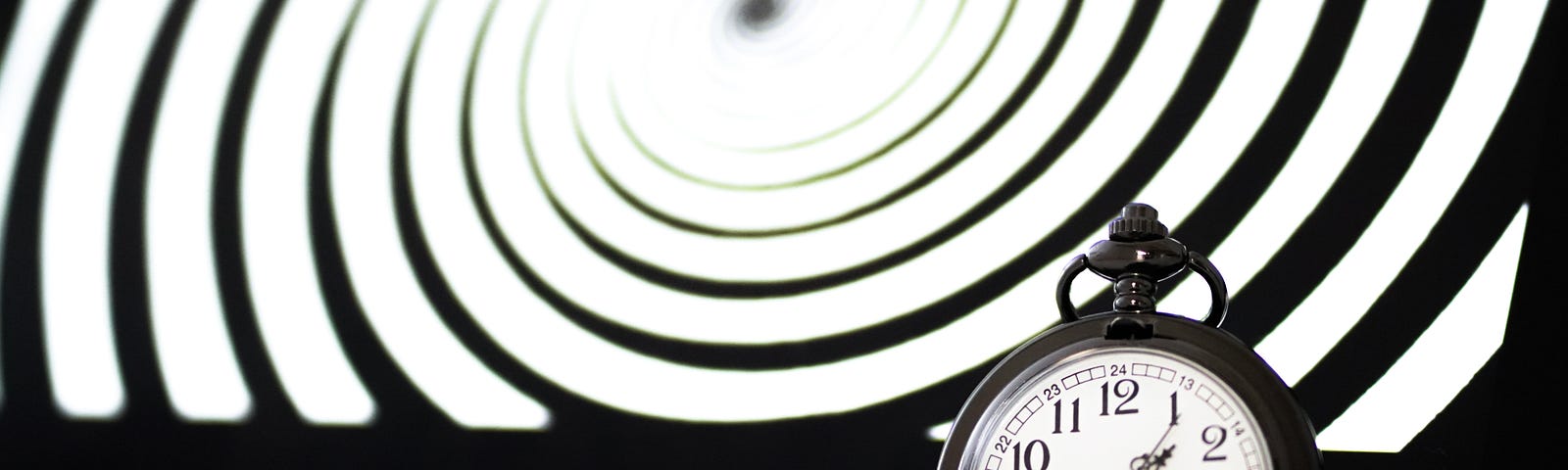 pocketwatch with spiral pattern in background