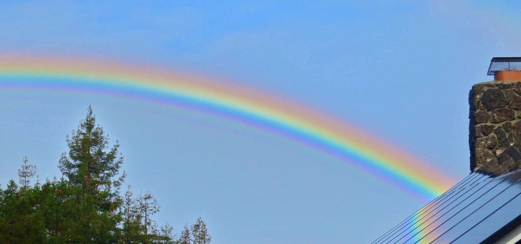 Rainbow behind the house.