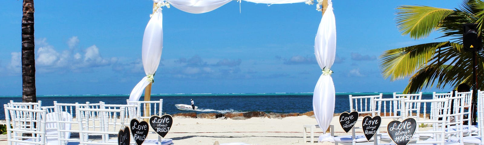 simple wedding canopy and chairs set on the beach ready for the ceremony.