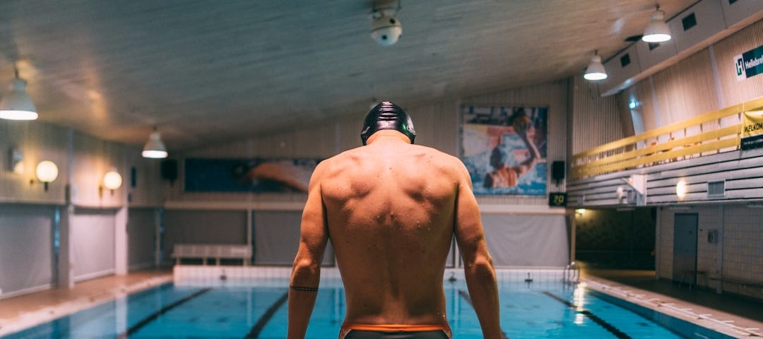 a swimmer just before beginning swimming near the pool