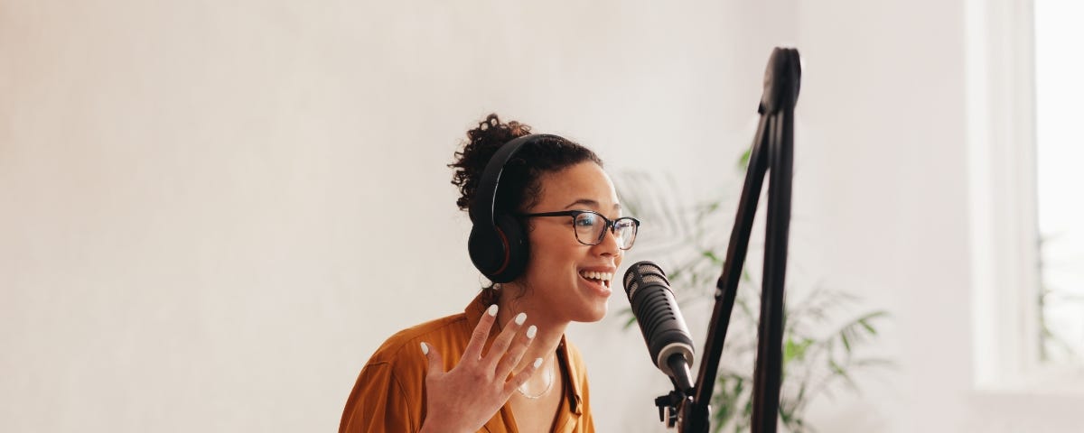 Woman talking into microphone for podcast