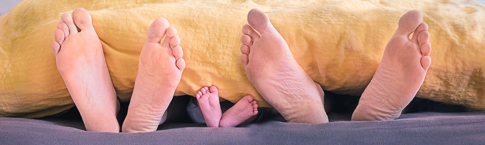 Three pairs of feet extend from underneath a yellow comforter. The middle ones’ are a baby’s. Move, and you can reduce your chances of suffering from chronic disease. You can lengthen your health- and lifespans. My physical activity helps me ward off cognitive decline, too.