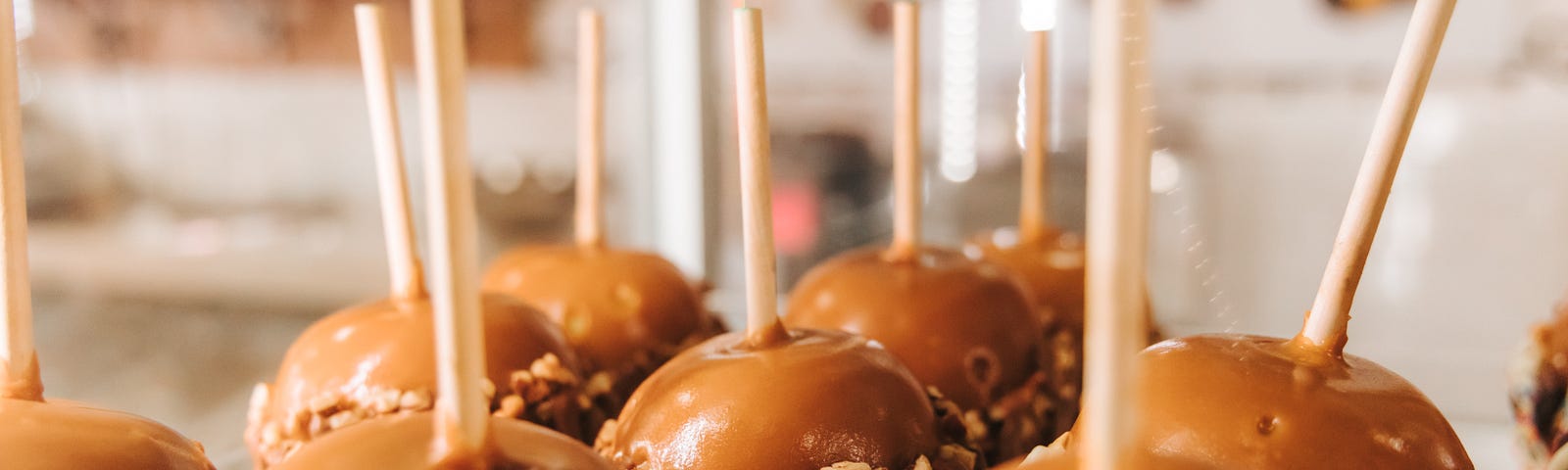 A tray of caramel apples dipped in nuts