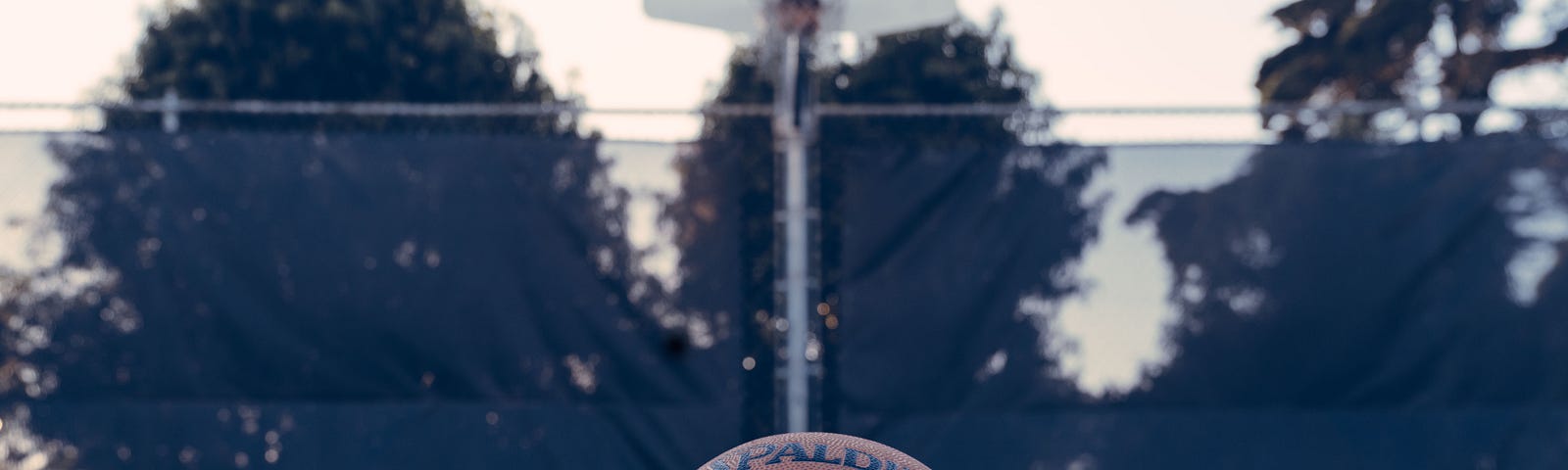 An NBA Basketball on an empty outdoor court.