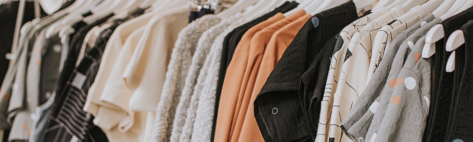 Neutral coloured clothing on a rack