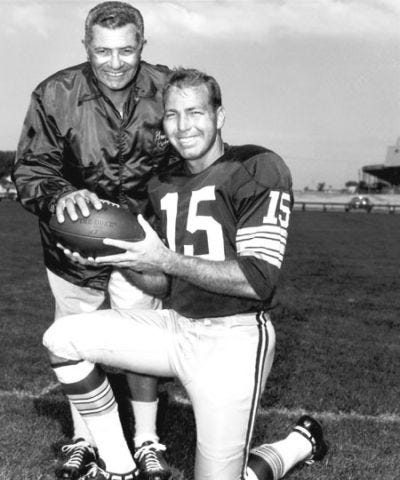 English Vince Lombardi (left) and Packers quarterback Bart Starr pose together holding a football. Author Unknown, This work is in the public domain in the United States because it was published in the United States between 1928 and 1977, inclusive, without a copyright notice.File:Vince lombardi bart starr.jpg — Wikimedia Commons