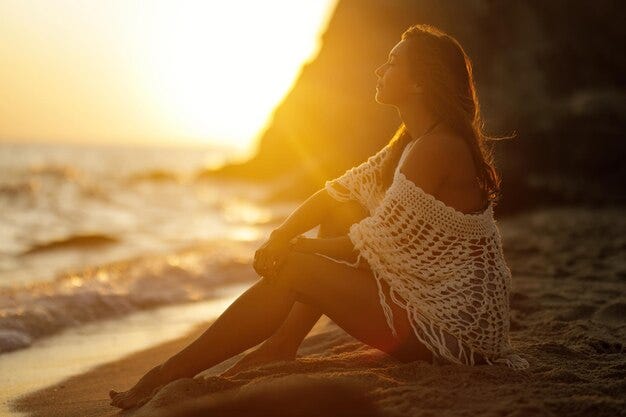 Young woman basking in the sun’s rays at sunset