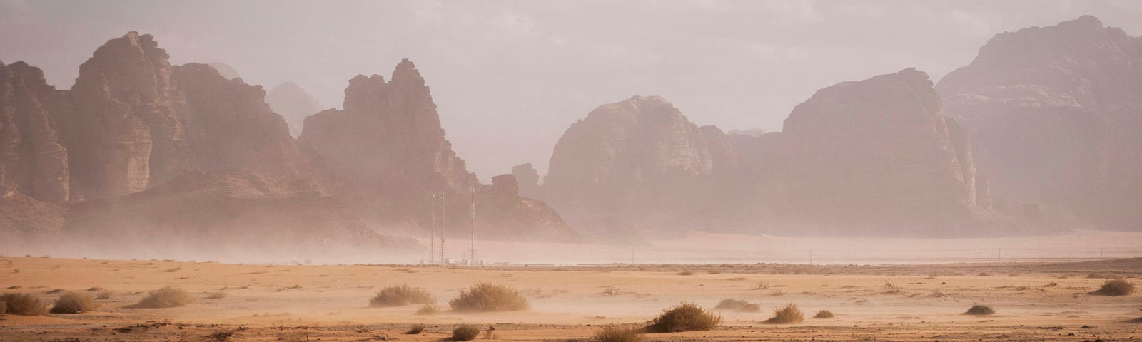 you can see a dessert with large rock formations in the background