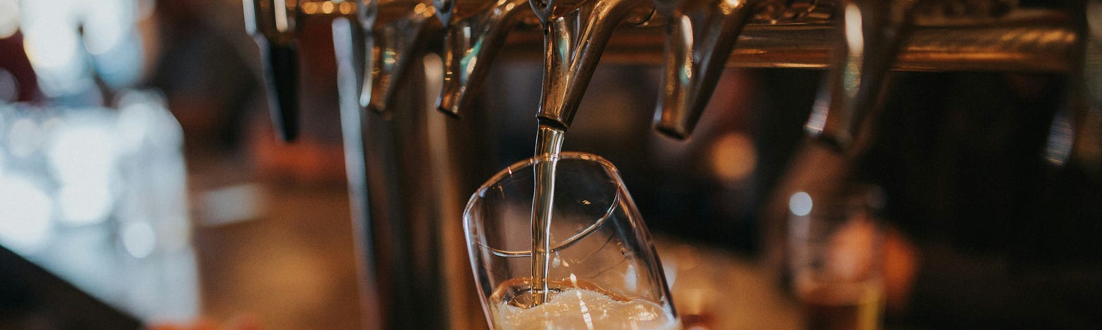 Filling up a glass with beer from the tap