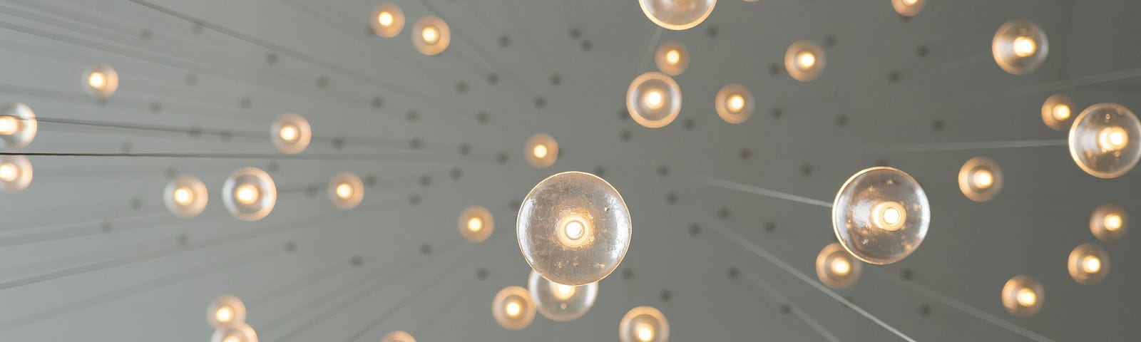 Multiple lights hanging from a ceiling.