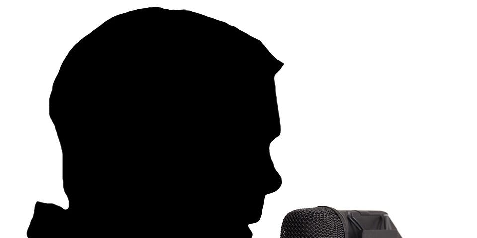 Silhouette of a man at a microphone