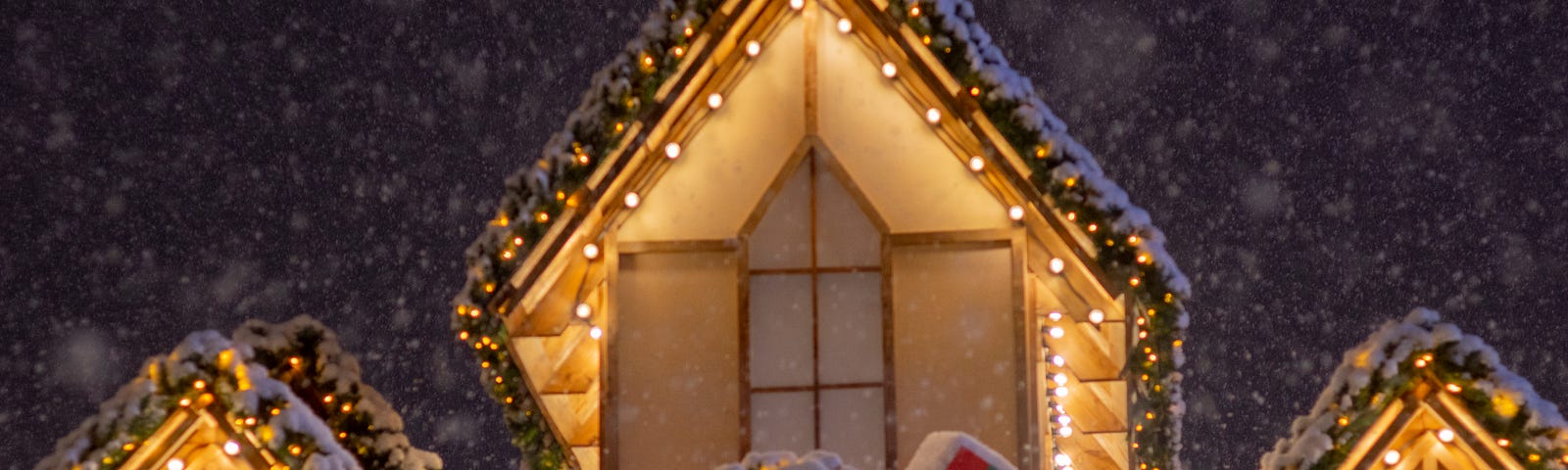 A snowy building with fairy lights.