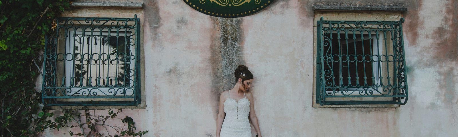 A bride under a sign that says, “Antiques”