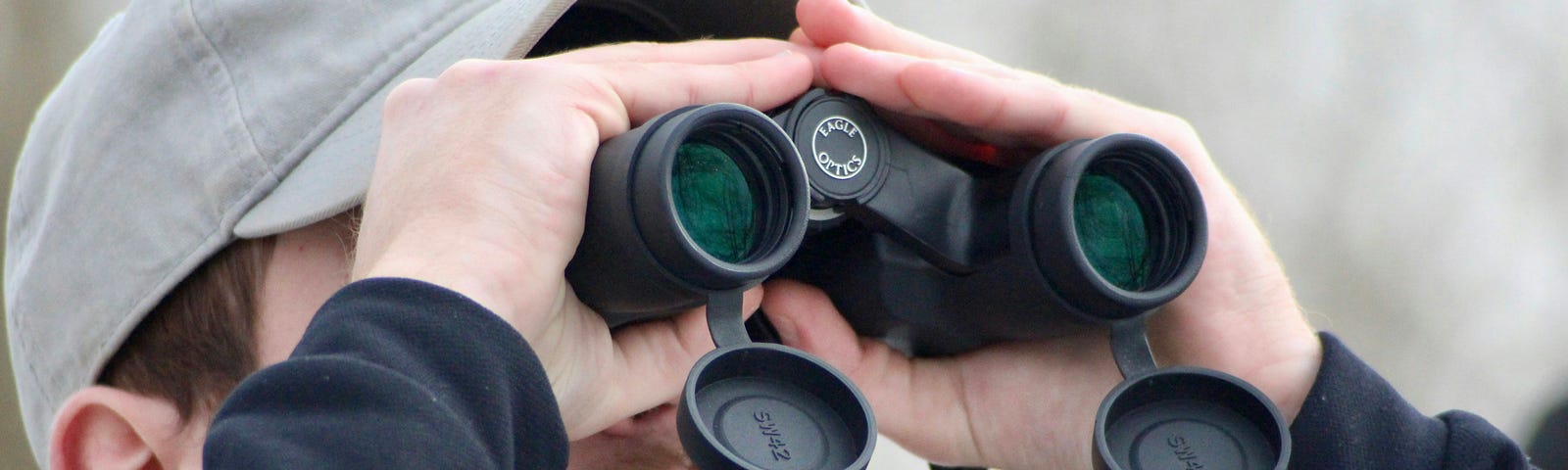 Man staring through binoculars.