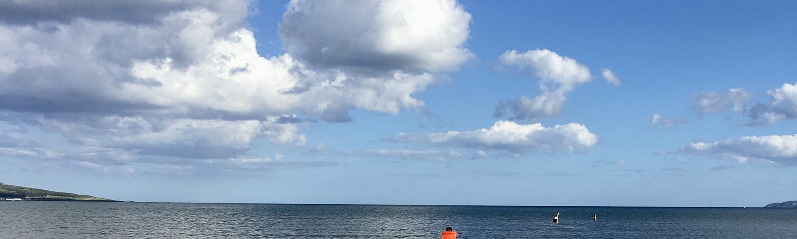 A boy dips his toes in the sea.