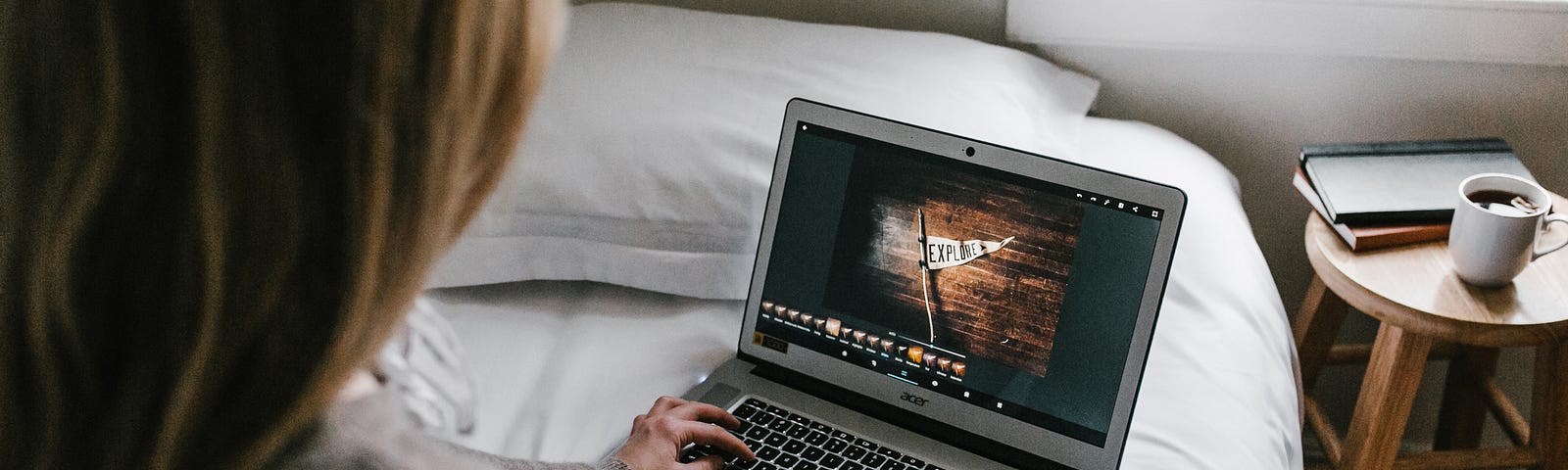 a woman sitting on her bed and writing a story on her MacBook. This is a picture to enhance the theme of the article, which talks about writers block and how I believe it’s a myth and can be defeated.