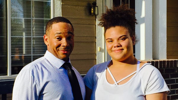 Calvin Burns, 35, and his daughter Stepheni Bellamy, 15, talk about their experiences with racism during a StoryCorps interview in Denver.