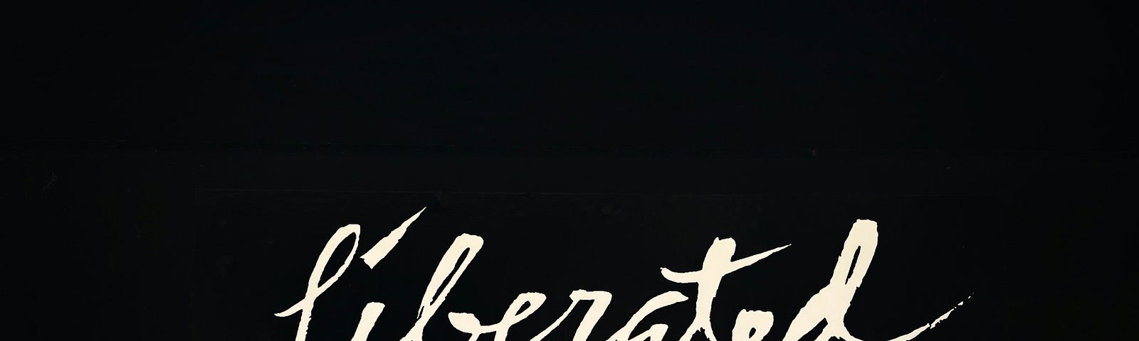 LIberated in cursive on a black background.