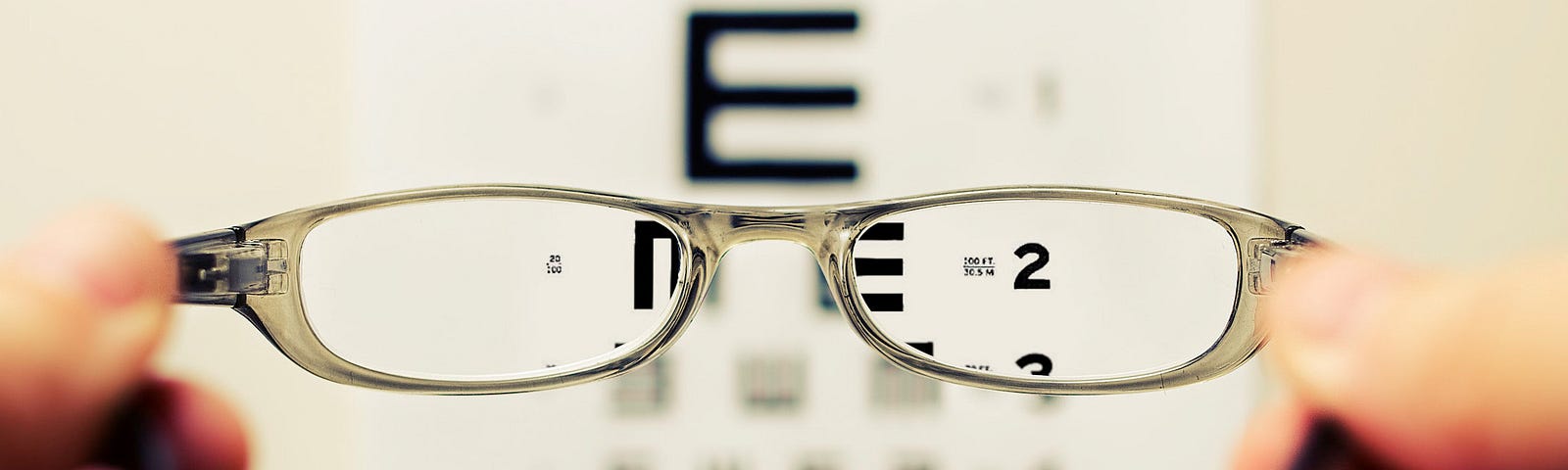 A person’s hands holding an eyeglasses for sight checking.