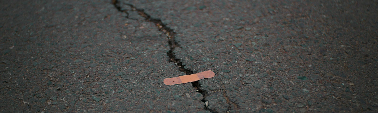 A crack in the sidewalk symbolizing a scar.