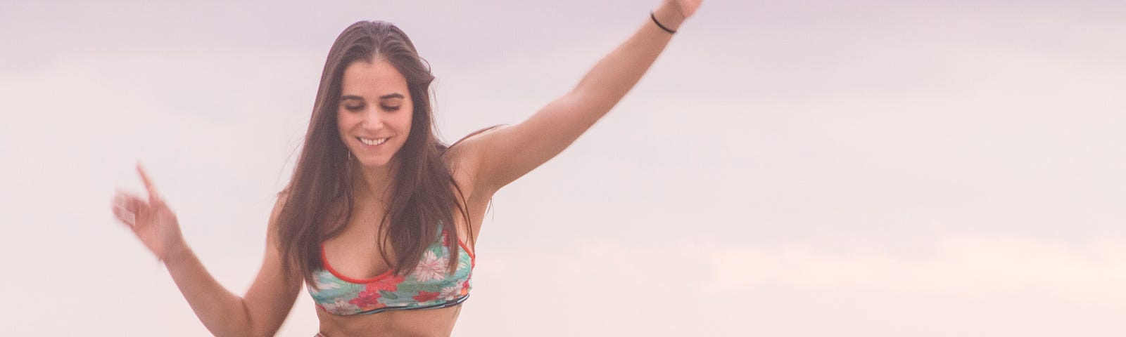 A young woman balancing on a board.