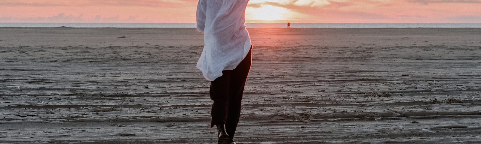 Here is a photo of a young woman at the beach, seeing the beauty of a sunset, representing the beauty of God’s creation.
