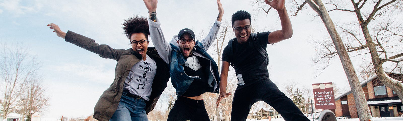 Friends jumping with joy in the snow