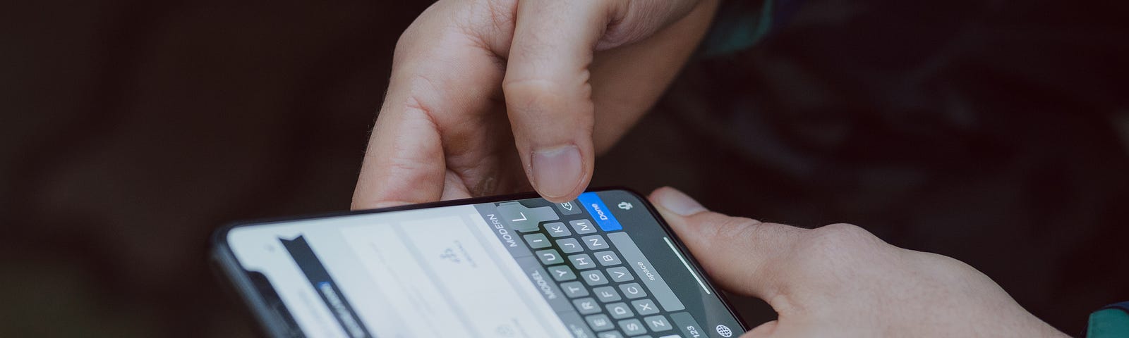 selective focus photography of a person using iPhone