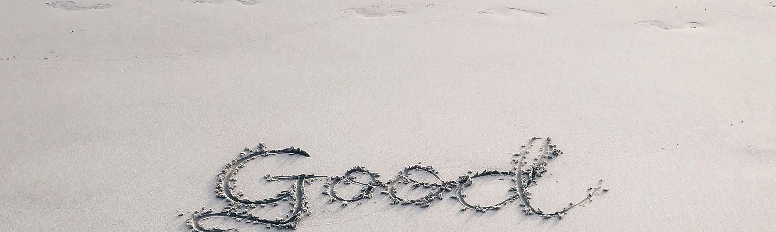 on the beach written in sand, “Good Vibes Only”